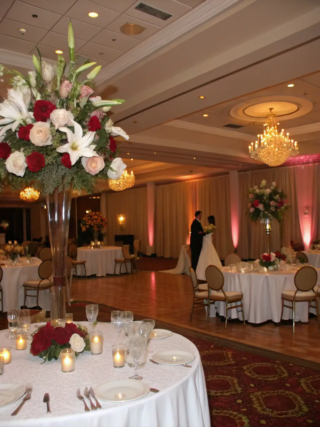 A beautifully decorated wedding reception with elegant floral arrangements and soft lighting, showcasing The List Event Planning's expertise in creating romantic wedding atmospheres.